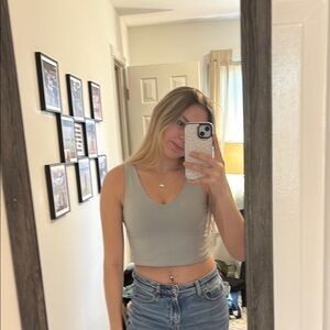 Gray sleeveless crop tank top with crew neck and fitted style